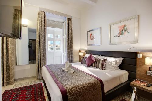 a bedroom with a large bed and a window at Palazzo Paolina Boutique Hotel in Valletta
