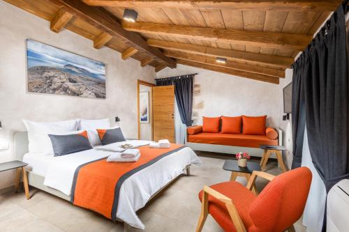 a bedroom with a bed and a couch at Luxury Jerini Barn in Krk