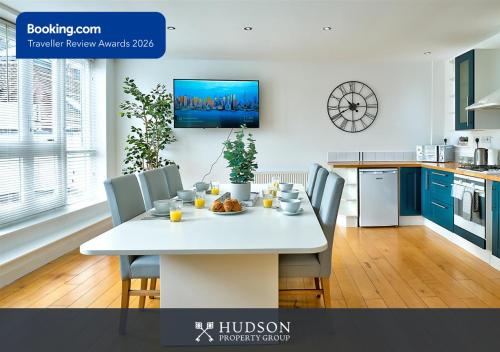 a kitchen with a white table and blue cabinets at Ironbridge Townhouse with Roof Terrace and Parking in Ironbridge