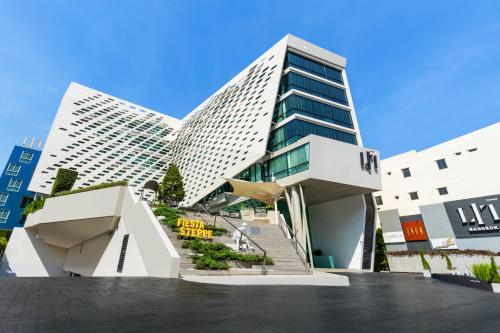 a large building with stairs in front of it at LiT BANGKOK Hotel in Bangkok