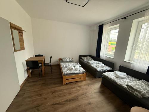 a living room with two couches and a table at Hostel Granat in Czekanów