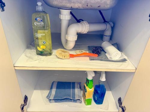 a shelf with a sink and cleaning products under a sink at Unit 4 - Stawell, Golden Patch Retreat in Stawell