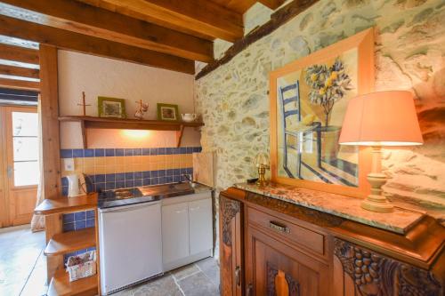 a kitchen with a counter with a lamp on it at Domaine d'Essendiéras in Saint-Médard-dʼExcideuil
