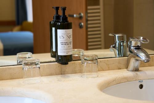 a bottle of wine sitting on top of a bathroom sink at II Castillas Madrid in Madrid