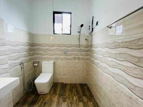 a bathroom with a toilet and a sink at Ella White Tea Garden Hotel in Ella