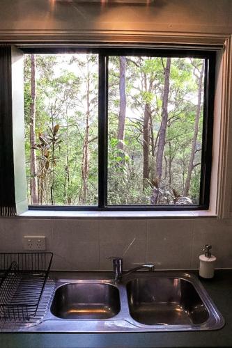 a kitchen sink with a window above it at GREEN TREES CHALET Australia Zoo close by in Landsborough