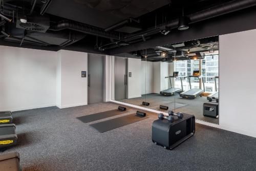 an empty room with a tv and a gym at Crowne Plaza Geelong by IHG in Geelong