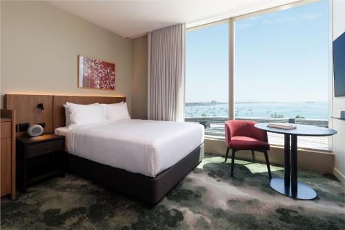 a hotel room with a bed and a table and a window at Crowne Plaza Geelong by IHG in Geelong