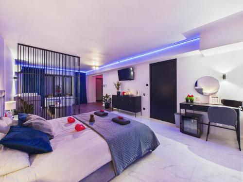 a large bedroom with a large bed with blue lighting at Jacuzzi LoveAparts Marki Romantic Getaway in Marki