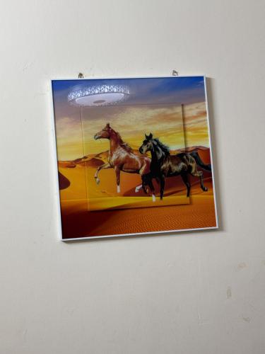 a picture of two horses running on a wall at Intermass building in Sharjah