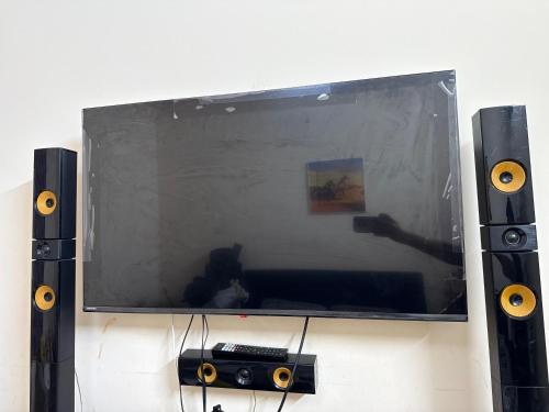 a tv with a reflection of a person taking a picture at Intermass building in Sharjah