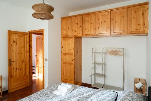 a bedroom with a bed and wooden cabinets at Sila Magico Incanto in Camigliatello Silano