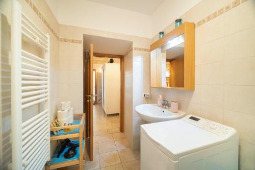 a bathroom with a sink and a washing machine at Le Contrade via Roma in Monopoli