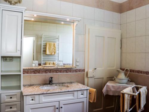 a bathroom with a sink and a mirror at Rosenvilla - Musikerschlössl in Bad Ischl