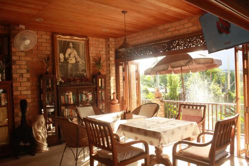 a dining room with a table and chairs at Sea Pines & Liberg in Nai Yang Beach
