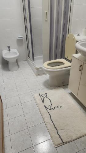 a bathroom with a toilet and a sink at Serenity Naxos Vacation Home in Giardini Naxos