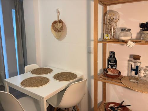 a white table with four chairs in a room at Autor Guesthouse in Vila do Conde