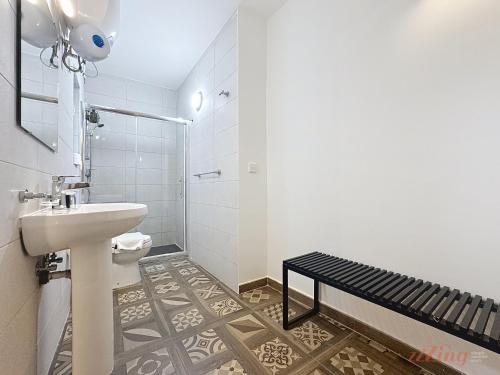 a white bathroom with a sink and a shower at Chic 4BR Maltese Gem with Game Room in Siġġiewi in Siġġiewi