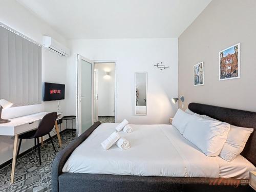a hotel room with a bed and a desk at Chic 4BR Maltese Gem with Game Room in Siġġiewi in Siġġiewi