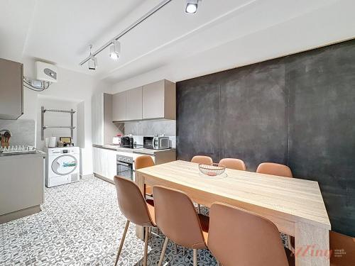 a kitchen with a table and chairs and a blackboard at Chic 4BR Maltese Gem with Game Room in Siġġiewi in Siġġiewi