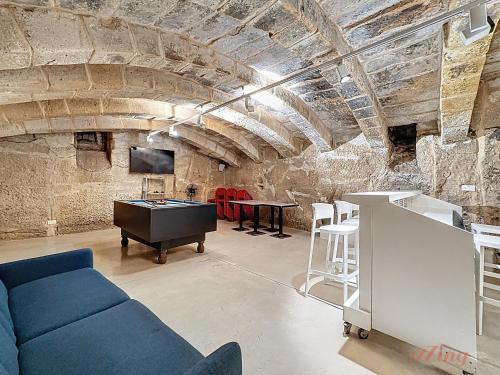 a living room with a blue couch and a table at Chic 4BR Maltese Gem with Game Room in Siġġiewi in Siġġiewi
