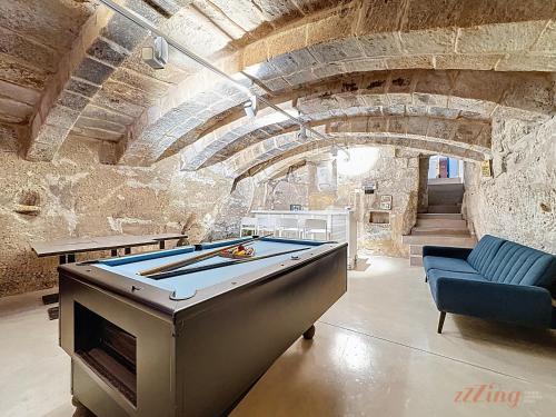 a large room with a pool table in a building at Chic 4BR Maltese Gem with Game Room in Siġġiewi in Siġġiewi