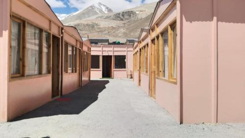 an empty corridor of a building with mountains in the background at Hill Side Cabin, Pangong in Spangmik