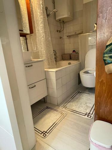 a small bathroom with a sink and a toilet at Studio apartman Providenca in Split