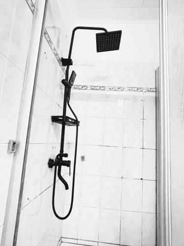 a shower with a shower head in a bathroom at Bulle d'Or PREMIUM in Libreville