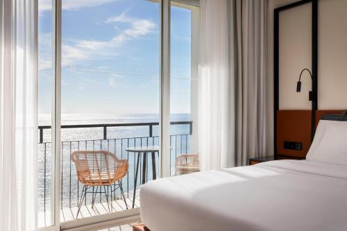 ein Schlafzimmer mit Bett und Meerblick in der Unterkunft Hotel Riomar Ibiza, a Tribute Portfolio Hotel in Santa Eulària des Riu