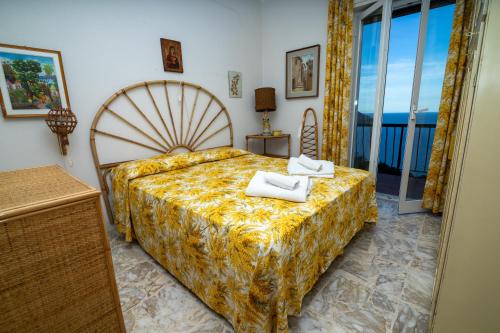 a bedroom with a large bed with towels on it at Villa Ciacia in Cervo