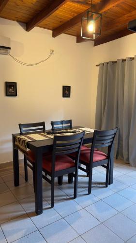 a dining room table with two chairs and a table at Yvyrá Duplex in Eldorado