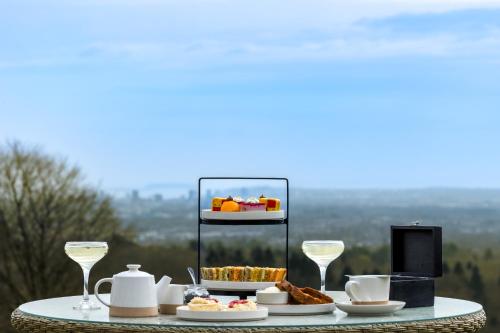 a table with a tray of food and wine glasses at New House Country Hotel in Cardiff