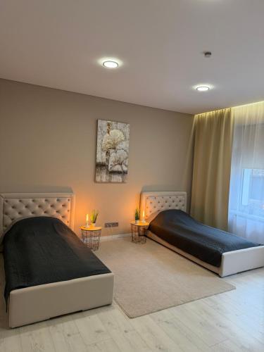 a bedroom with two beds and a window at White Home by Gerda in Etgersleben