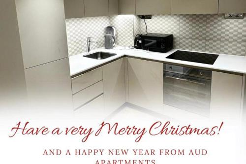 a white kitchen with a happy new year greetings message at London - Apartment - Sleeps 2 - Garden - Pool in Hendon