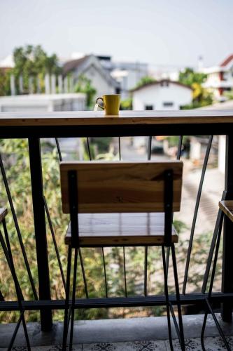 a table with a coffee cup on top of it at Le Neuf Nakorn Lampang in Lampang