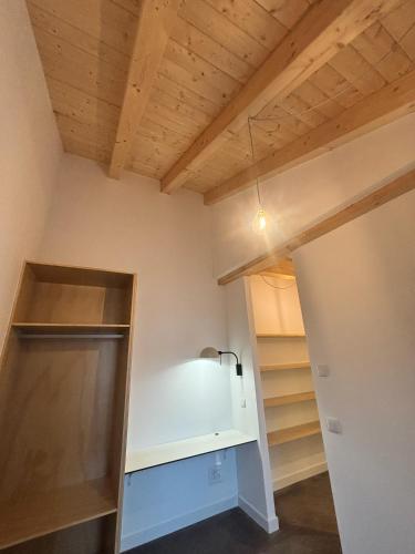 a room with a closet with wooden ceilings at El Santo Hostel in Burgos