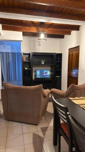 a living room with a couch and a television at Yvyrá Duplex in Eldorado