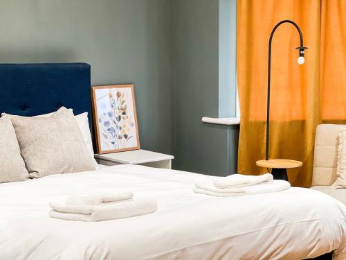 a bedroom with a bed with towels on it at Zozy Anson in London