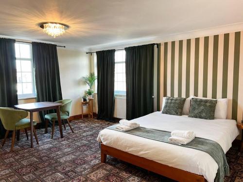 a hotel room with a bed and a table at Zozy Anson in London