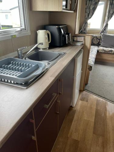 a kitchen with a sink and a counter top at Caravan at the seaside in Great Yarmouth