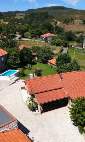 an aerial view of a house with red roofs at Casa da Rosa Porreiras in Paredes de Coura