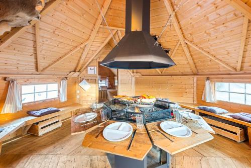 a kitchen with a stove in a wooden cabin at Alpen Chalets Ausseerland - Sauna & BBQ in Bad Mitterndorf