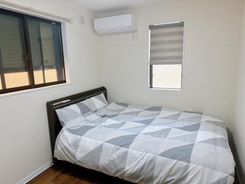 a bed in a bedroom with a window and a bed sidx sidx sidx at HB Home TOKYO in Tokyo
