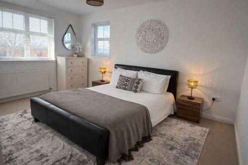 a bedroom with a bed and two lamps and a mirror at BraeView House in Inverness