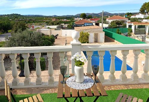a balcony with a table with a vase on it at La Villa Blanca in Pedralba