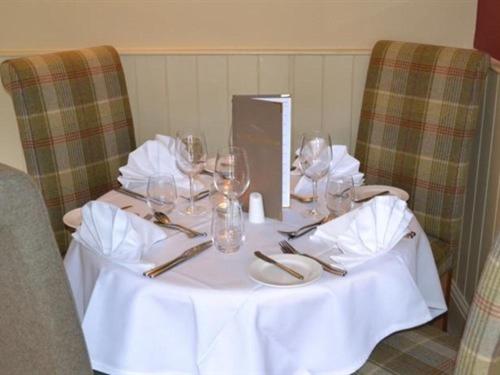 a table with wine glasses on top of it at The Stapylton Arms in Wass