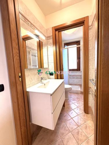 a bathroom with a sink and a toilet at Palme in San Vincenzo