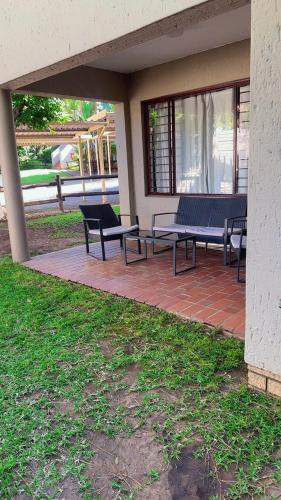 two benches sitting on a patio in a building at House by balinty in Johannesburg