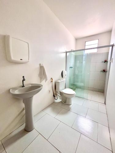 a bathroom with a toilet and a sink and a shower at POUSADA ESTRELA DA MANHÃ in Barreirinhas